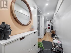 Toronto (East End-Danforth) apartment for rent - A hallway with a statue on the left and a mirror on the wall.