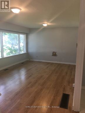Newmarket (Huron Heights-Leslie Valley) apartment for rent - A room with wooden flooring and a window letting in natural light.