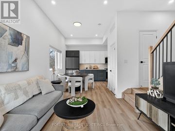 North York apartment for rent - A modern living room with a grey sofa and a black coffee table.