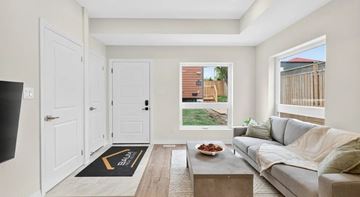 Etobicoke apartment for rent - A living room with a grey couch and a coffee table.