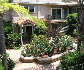 San Diego apartment for rent - A garden with a gazebo and a staircase leading to a balcony.