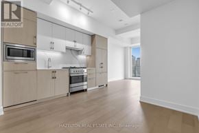 Toronto (Yonge-Eglinton) condo for rent - A modern kitchen with wooden floors and stainless steel appliances.