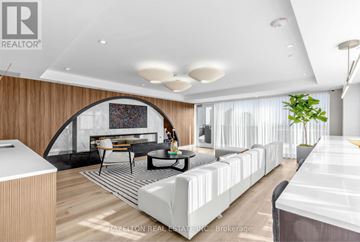 Toronto (Yonge-Eglinton) condo for rent - A modern living room with a white sofa and a wooden accent wall.