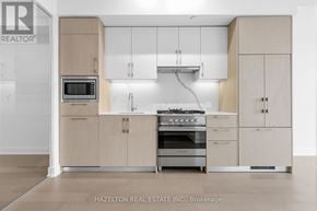 Toronto (Yonge-Eglinton) condo for rent - A modern kitchen with a stove top oven and microwave.