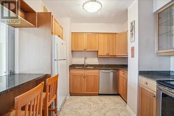 Toronto (Islington-City Centre West) condo for rent - A kitchen with wooden cabinets and granite countertops.