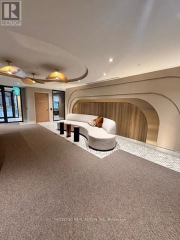 Toronto (Yonge-Eglinton) condo for rent - A modern living room with a white sofa and a wooden bench.