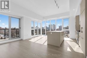 Toronto (Yonge-Eglinton) condo for rent - A spacious, empty room with a view of the city skyline through large windows.