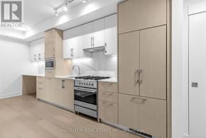 Toronto (Yonge-Eglinton) condo for rent - A modern kitchen with wooden cabinets and stainless steel appliances.