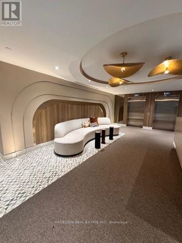 Toronto (Yonge-Eglinton) condo for rent - A modern living room with a curved sofa and a wooden accent wall.