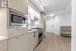 Toronto (Yonge-Eglinton) condo for rent - A modern kitchen with wooden cabinets and stainless steel appliances.