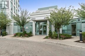 Mississauga (Central Erin Mills) condo for rent - The image shows the front of a building with the number 4850 and 4900 on it, with trees and bushes in front.