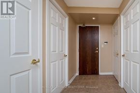 Mississauga (Central Erin Mills) condo for rent - A hallway with white doors and a brown door in the middle.