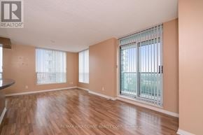 Mississauga (Central Erin Mills) condo for rent - A room with wooden flooring and a sliding glass door.