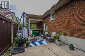 London South (South G) apartment for rent - A patio with a blue and white striped rug, a table with chairs, and a potted plant.