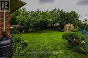 London South (South G) apartment for rent - A backyard with a green lawn and a shed.