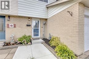Hamilton townhouse for rent - A house with a blue door and a white garage door.