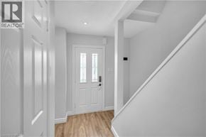 Hamilton townhouse for rent - A hallway with a white door and a window with blinds.