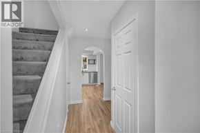 Hamilton townhouse for rent - A hallway with a staircase and a door.