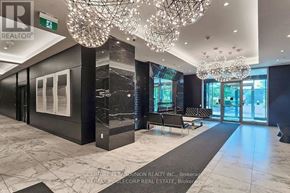 Toronto (Clanton Park) condo for rent - A spacious lobby with a marble floor and a large chandelier.