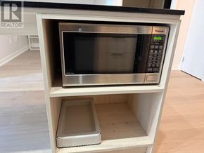 Toronto (Clanton Park) condo for rent - A microwave oven is built into a cabinet.
