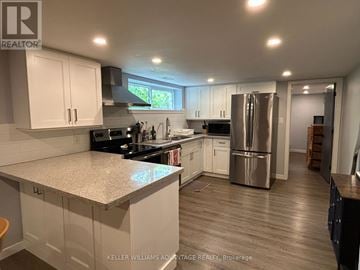 Toronto (Woburn) apartment for rent - A kitchen with white cabinets and a granite countertop.