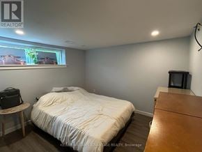 Toronto (Woburn) apartment for rent - A bedroom with a bed, a small table, and a television.