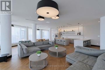Mississauga (Central Erin Mills) condo for rent - A modern living room with a grey sofa set and a coffee table.