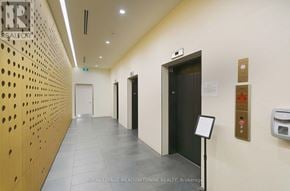 Mississauga (Central Erin Mills) condo for rent - A hallway with a sign that says "Royal LePage Meadowtowne Realty, Brokerage.".
