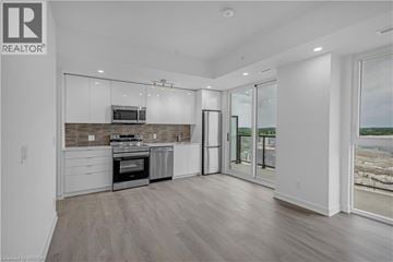 Brantford condo for rent - A modern kitchen with a stainless steel oven and microwave.
