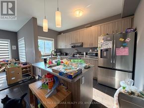 Welland (Lincoln/Crowland) apartment for rent - A kitchen with a refrigerator, microwave, and other appliances.