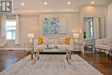 Toronto (Woodbine-Lumsden) apartment for rent - A living room with a glass table and a large abstract painting on the wall.