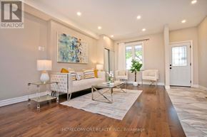 Toronto (Woodbine-Lumsden) apartment for rent - A well-lit living room with a white sofa and a glass coffee table.