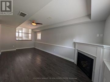 Innisfil (Alcona) apartment for rent - A large, empty room with a fireplace and wood flooring.