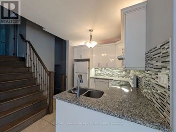 Innisfil (Alcona) apartment for rent - A kitchen with granite countertops and a staircase.