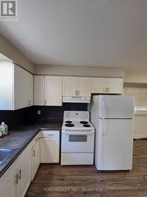 London East (East I) apartment for rent - A kitchen with white appliances and cabinets.
