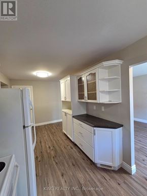 London East (East I) apartment for rent - A kitchen with white cabinets and a black countertop.