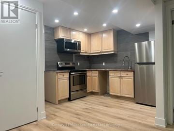 Burlington (Brant) apartment for rent - A kitchen with wooden cabinets and stainless steel appliances.