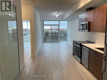 Barrie (Painswick South) condo for rent - A kitchen with wooden floors and a view of the city through the window.