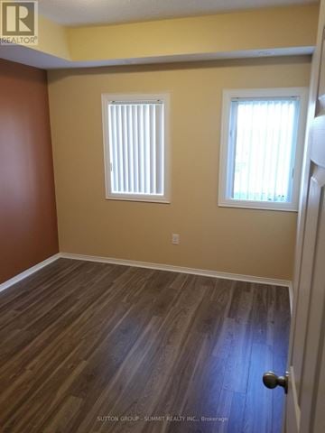 Mississauga (Churchill Meadows) condo for rent - A room with wooden flooring and two windows.