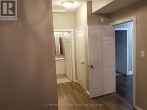 Mississauga (Churchill Meadows) condo for rent - A hallway with a white door and a white cabinet.