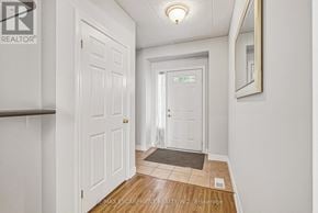 Burlington (Rose) townhouse for rent - A hallway with a door on the left and a mirror on the right.