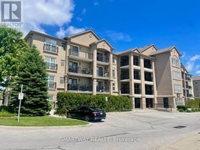 Milton (De Dempsey) condo for rent - A black car is parked in front of a building with a sign that says "SMARTWAY REALTY, Brokerage".