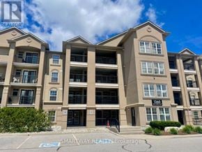 Milton (De Dempsey) condo for rent - A large apartment building with the number 1360 on the front.
