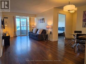 Markham (Unionville) condo for rent - A living room with a couch, chairs, and a television.