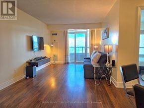 Markham (Unionville) condo for rent - A living room with a television, a couch, and a chair.
