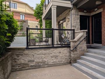 Vaughan (Islington Woods) townhouse for rent - A house with a stone wall and a metal railing.