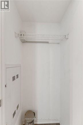 Toronto (Yorkdale-Glen Park) condo for rent - A white bathroom with a toilet and a shelf above it.