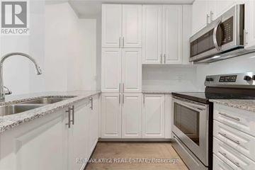 Toronto (Yorkdale-Glen Park) condo for rent - A kitchen with white cabinets and a stainless steel oven.
