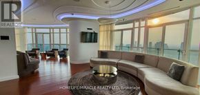 Mississauga (City Centre) condo for rent - A living room with a large window overlooking the city.