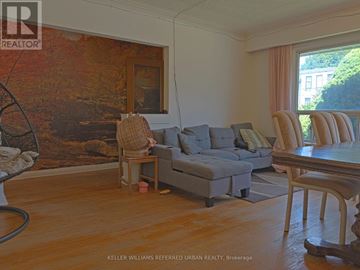 Toronto (Newtonbrook East) apartment for rent - A living room with a grey couch and a large painting on the wall.